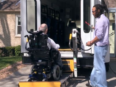 TNC-Community-Services TNC Community individual being helped into van by staff