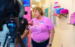 Kelly McGillis, TNC Community CEO being interviewed by press at Howdy Homemade Ice Cream grand opening