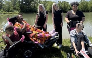 TNC Community individuals and staff by the pond at Spring Fun Day.